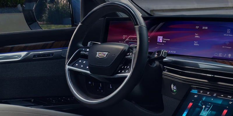 Premium Cadillac Escalade cockpit with steering wheel and digital screens.